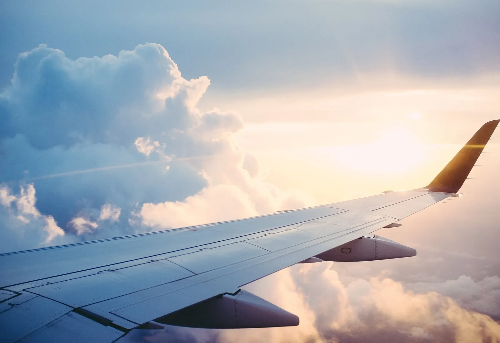 An aeroplane wing above the clouds